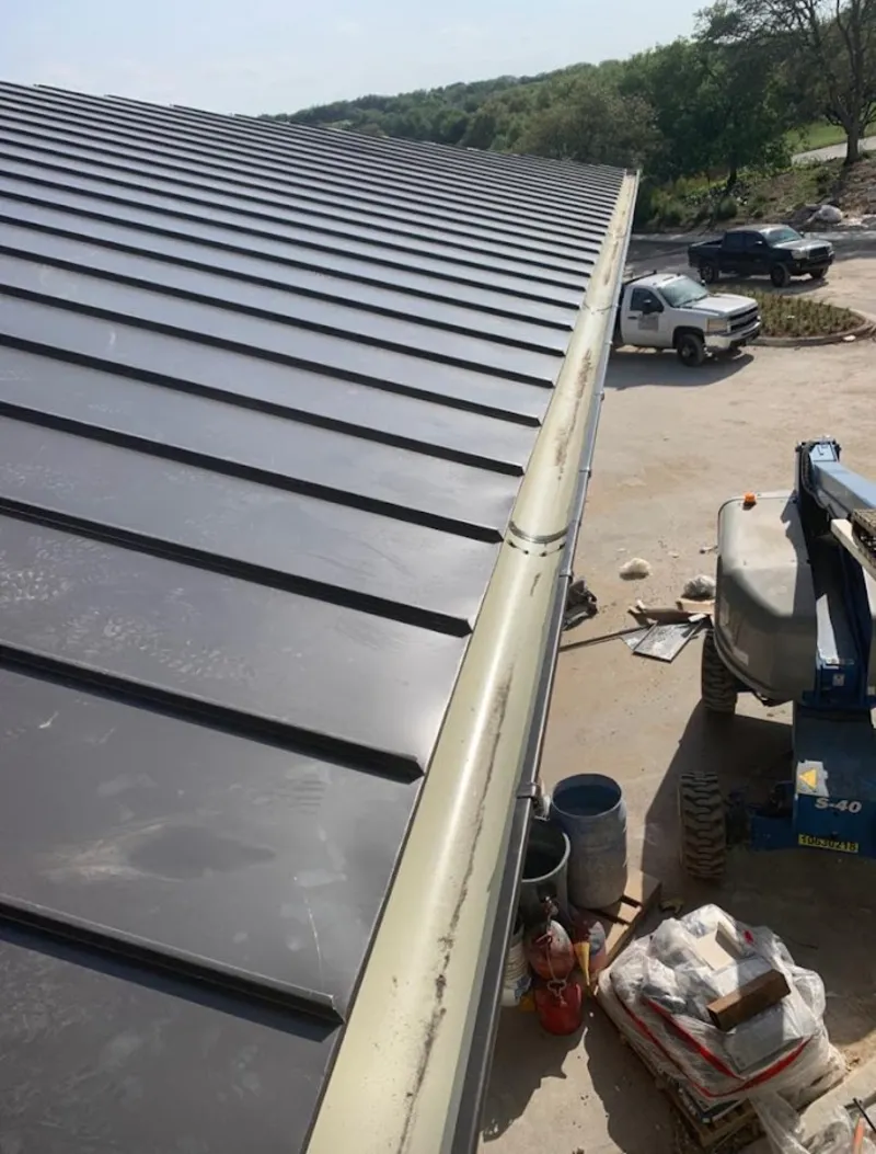 Standing seam panel and gutter detail on a metal roofing jobsite in Yucca Valley